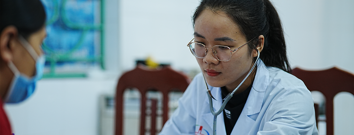 Clinician checking a patient's blood pressure.